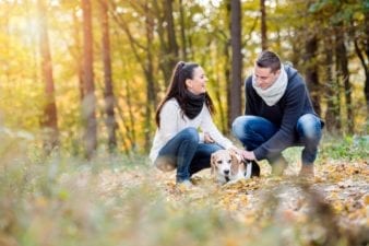 Couple Walking Their Dog in the Woods