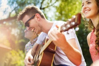 Man playing guitar with his friends