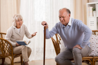 Old Man With Osteoarthritis Struggles to Stand