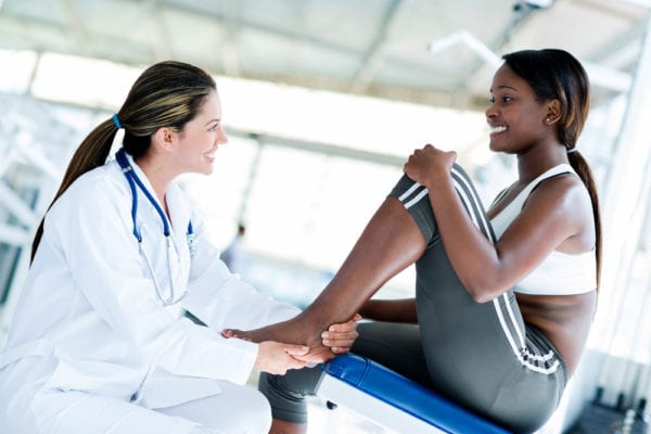 Athlete getting a doctor's diagnosis of her joint pain
