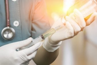 Doctor Prepares an Antibiotic Treatment Using a Syringe