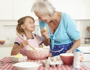 Grandmother and granddaughter baking during the holiday season