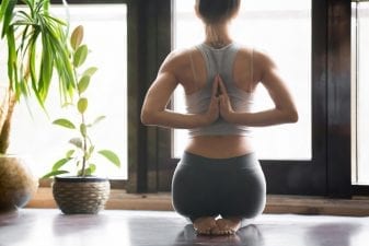 woman improving her posture and preventing posture pain through yoga