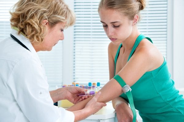 Woman getting her blood taken to test for gonorrhea
