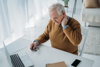Elderly man experiencing cervical neck pain