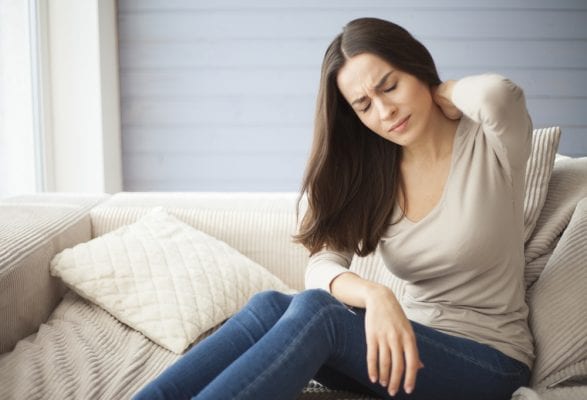A woman with sore neck pain